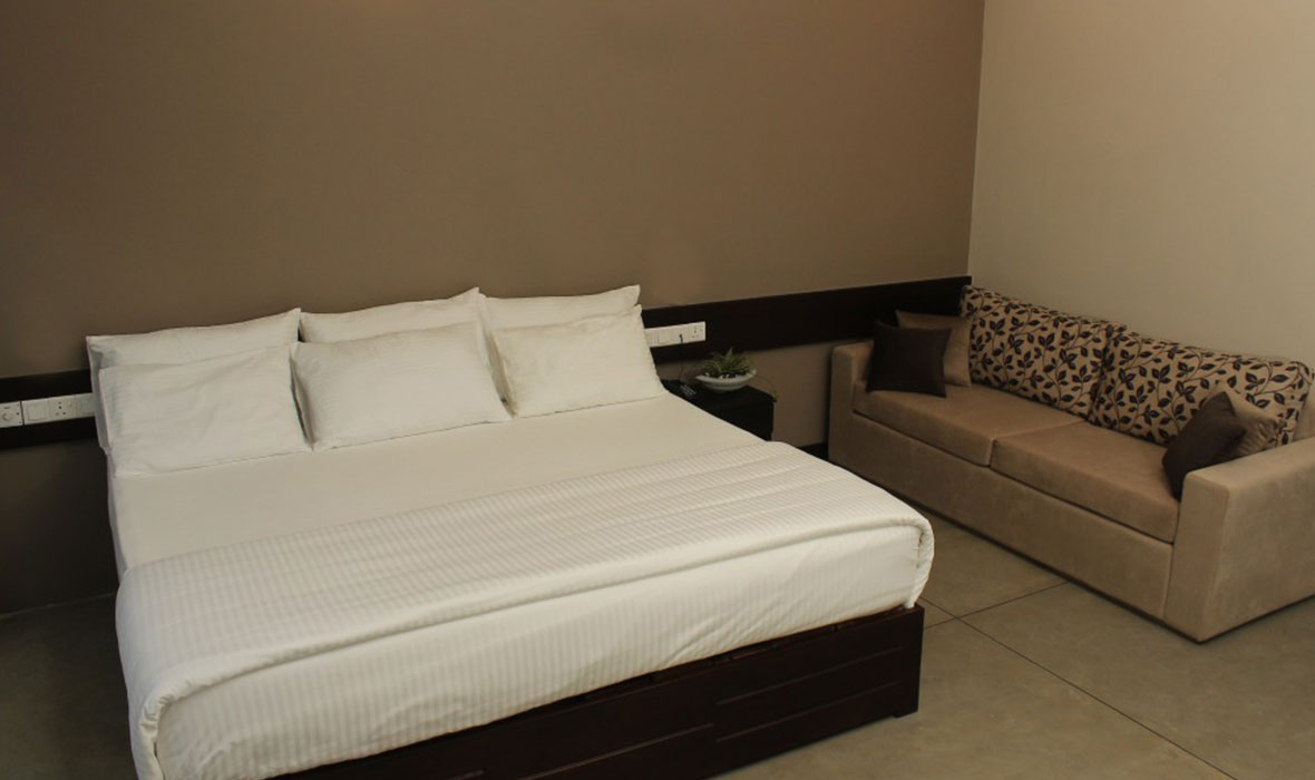 Comfortable Bed and Seating Area in Ahas Gawwa Deluxe Room